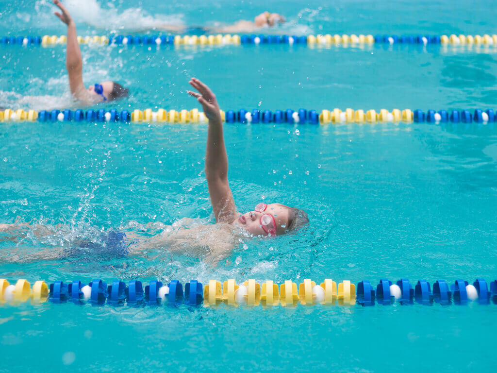 competitive swimmer using swimming strokes