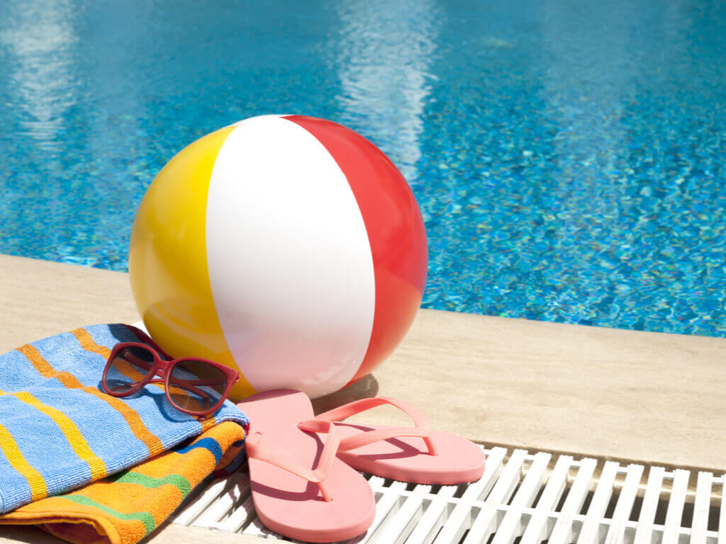 pool accessories next to a blue inground pool