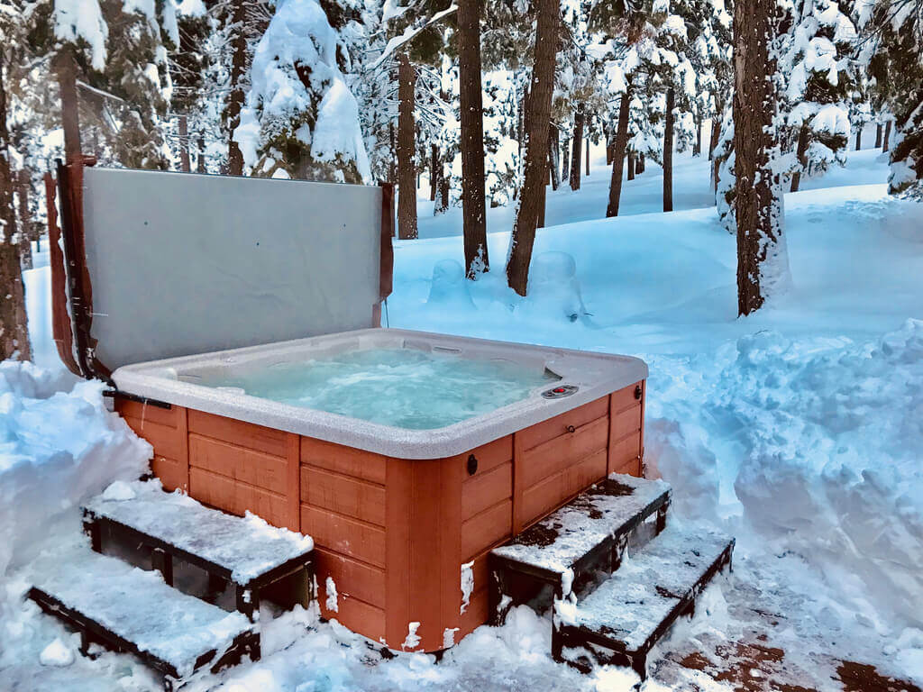 hot tub surrounded by snow
