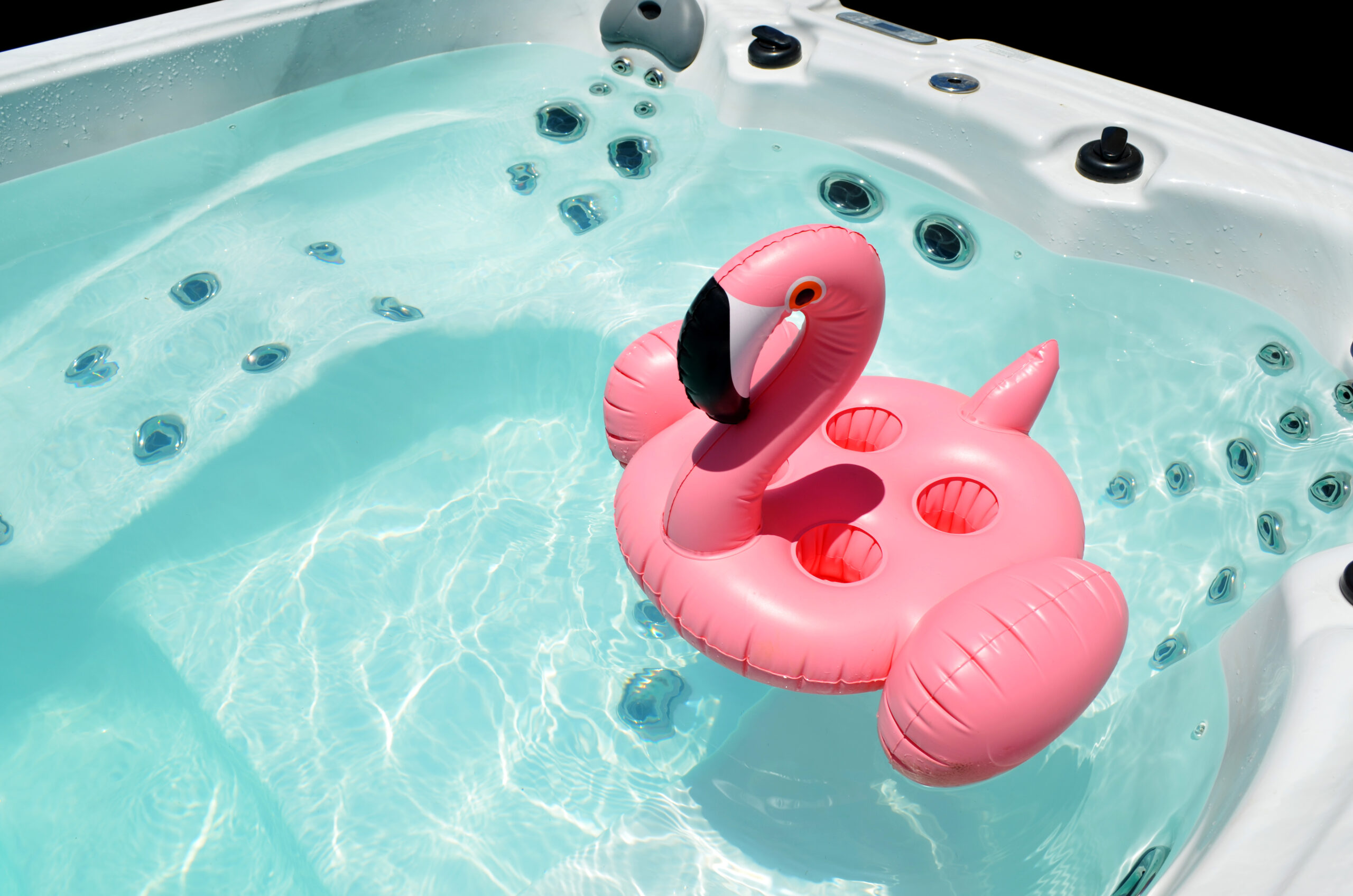 Hot tub with a flamingo floatie in it.